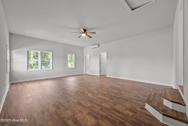 1496 Kellum Loop Rd, Jacksonville, NC 28546 - spare room featuring ceiling fan, dark wood-style floors, baseboards, and a wall unit AC