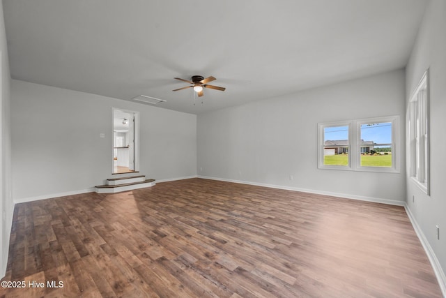 1496 Kellum Loop Rd, Jacksonville, NC 28546 - unfurnished room with wood finished floors, a ceiling fan, and baseboards