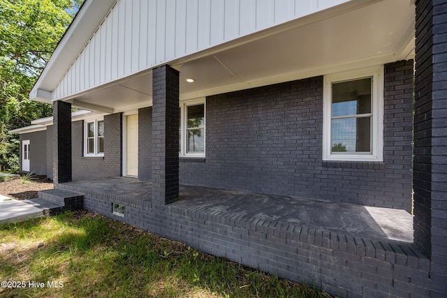 1496 Kellum Loop Rd, Jacksonville, NC 28546 - view of side of property with a porch, board and batten siding, and brick siding
