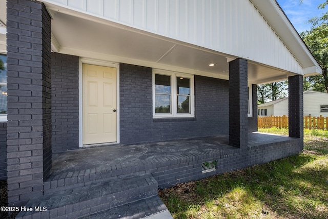 1496 Kellum Loop Rd, Jacksonville, NC 28546 - doorway to property featuring brick siding and covered porch