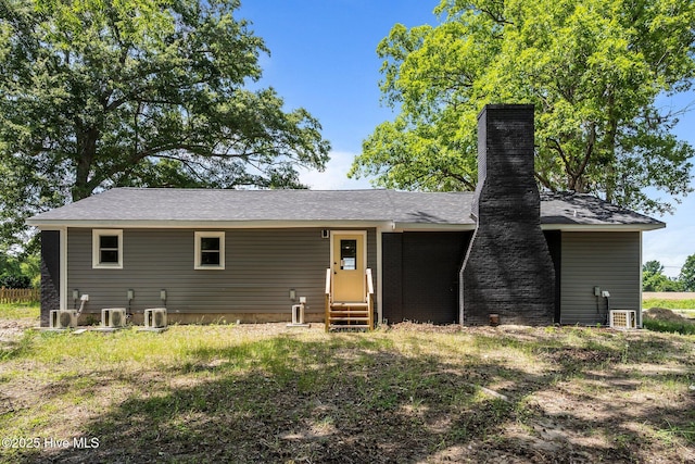 1496 Kellum Loop Rd, Jacksonville, NC 28546 - back of property with entry steps, a chimney, and central AC unit