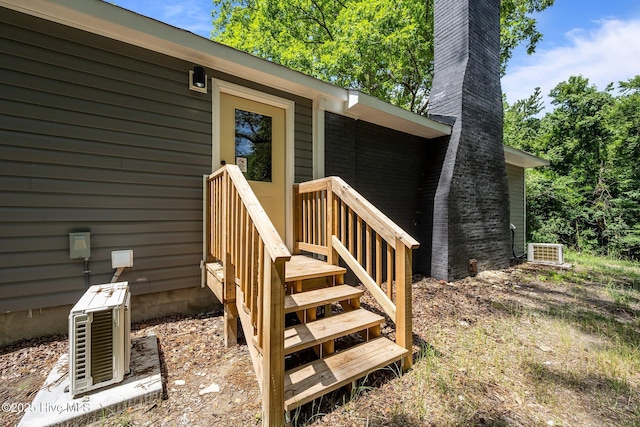 1496 Kellum Loop Rd, Jacksonville, NC 28546 - entrance to property with a chimney and central AC unit