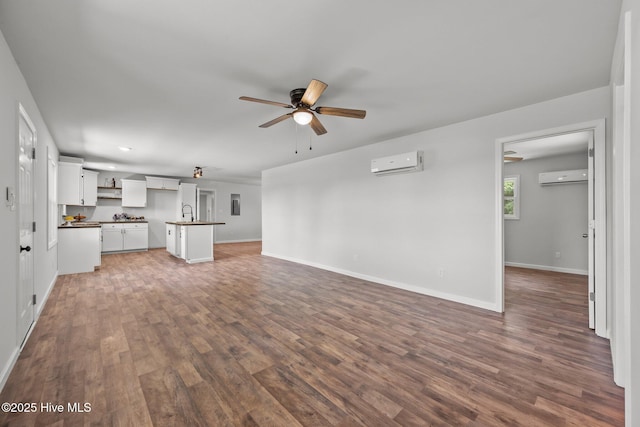 1496 Kellum Loop Rd, Jacksonville, NC 28546 - unfurnished living room with a wall mounted AC, ceiling fan, wood finished floors, and recessed lighting