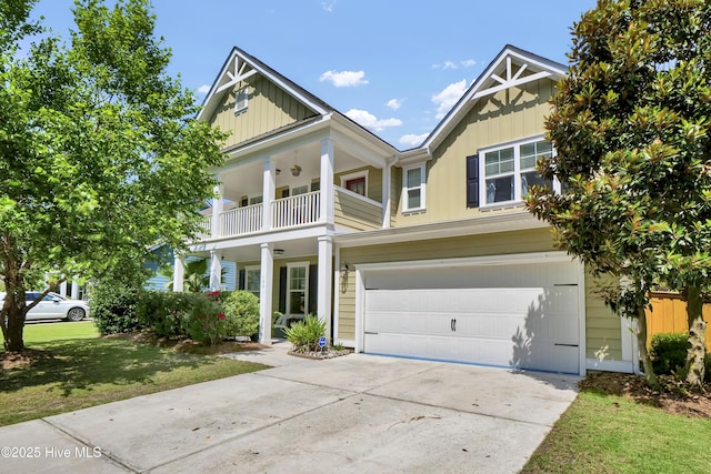 133 Overlook Dr, Wilmington, NC 28411 - view of front of property featuring a garage, concrete driveway, a balcony, and board and batten siding