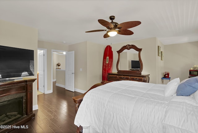 133 Overlook Dr, Wilmington, NC 28411 - bedroom with dark wood-type flooring, ceiling fan, and a fireplace