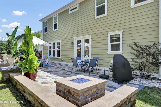 133 Overlook Dr, Wilmington, NC 28411 - back of house featuring an outdoor fire pit, a patio area, outdoor dining area, and french doors