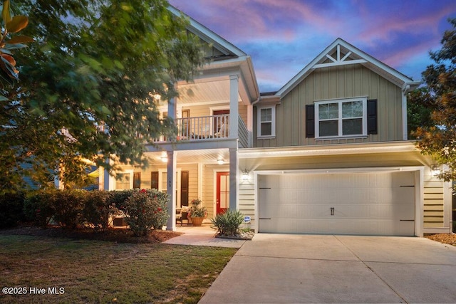 133 Overlook Dr, Wilmington, NC 28411 - view of front of house with board and batten siding, a balcony, concrete driveway, a garage, and covered porch