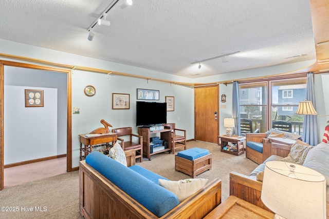 210 W Beach Dr, Oak Island, NC 28465 - living room with track lighting, light carpet, and a textured ceiling
