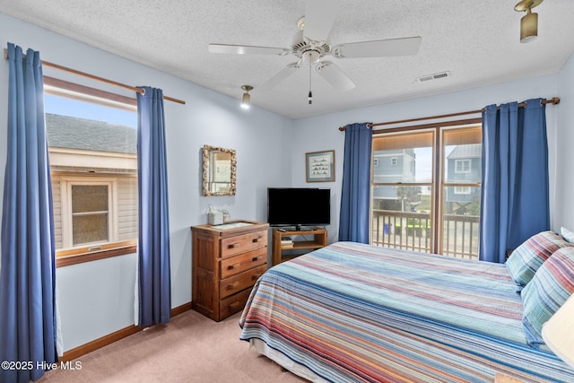 210 W Beach Dr, Oak Island, NC 28465 - bedroom featuring carpet, access to exterior, a textured ceiling, and ceiling fan