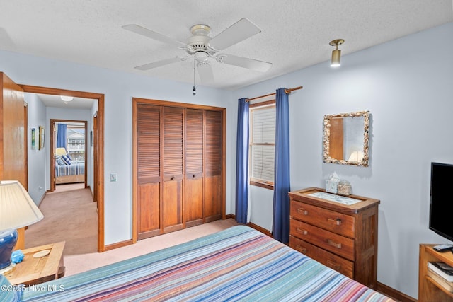 210 W Beach Dr, Oak Island, NC 28465 - bedroom with a closet, light colored carpet, a ceiling fan, and a textured ceiling