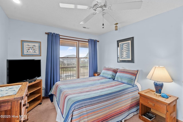 210 W Beach Dr, Oak Island, NC 28465 - bedroom featuring carpet, access to exterior, a ceiling fan, and a textured ceiling