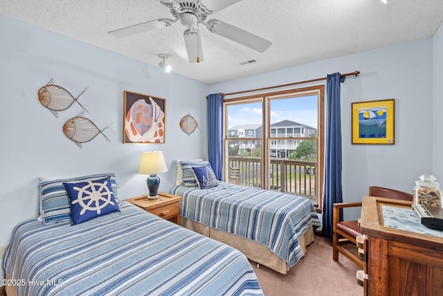 210 W Beach Dr, Oak Island, NC 28465 - bedroom featuring carpet floors, a textured ceiling, access to exterior, and ceiling fan