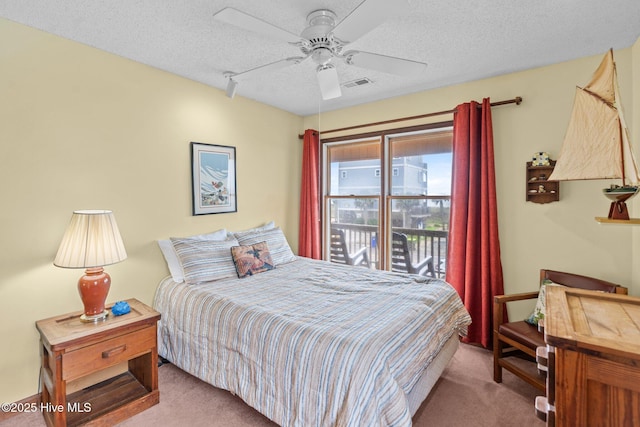 210 W Beach Dr, Oak Island, NC 28465 - carpeted bedroom with a textured ceiling and ceiling fan