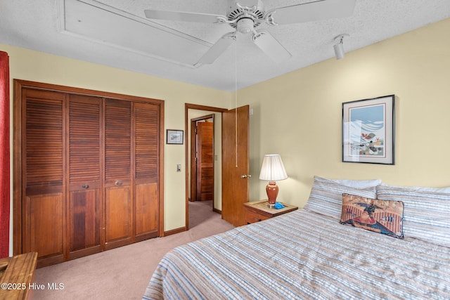 210 W Beach Dr, Oak Island, NC 28465 - bedroom with light colored carpet, a closet, and a ceiling fan