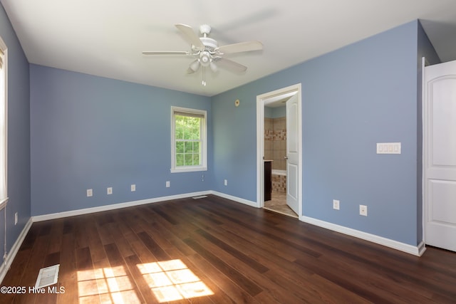 4173 Middle Rd, Trenton, NC 28585 - unfurnished bedroom featuring dark wood-style floors, ensuite bathroom, and a ceiling fan