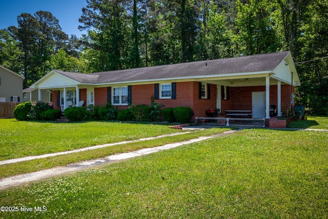 4173 Middle Rd, Trenton, NC 28585 - ranch-style home with a porch, brick siding, a front lawn, and a carport