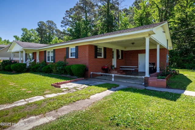 4173 Middle Rd, Trenton, NC 28585 - ranch-style home with a front yard and brick siding
