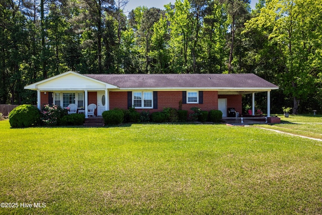 4173 Middle Rd, Trenton, NC 28585 - ranch-style home featuring covered porch, brick siding, a front lawn, and an attached carport