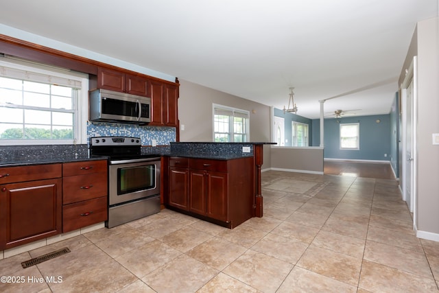 4173 Middle Rd, Trenton, NC 28585 - kitchen featuring appliances with stainless steel finishes, backsplash, a ceiling fan, a peninsula, and dark stone countertops