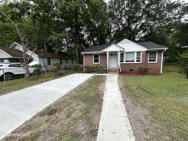 1310 Washington St E, Wilson, NC 27893 - bungalow featuring concrete driveway, crawl space, and brick siding