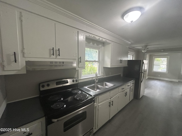 1310 Washington St E, Wilson, NC 27893 - kitchen with stainless steel appliances, under cabinet range hood, white cabinets, wood finished floors, and ornamental molding