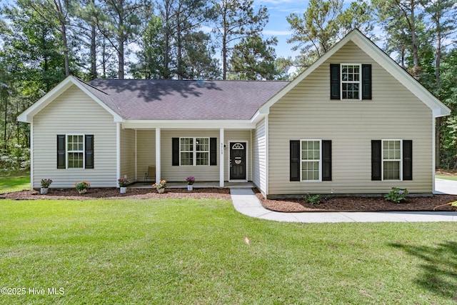 5709 Burgaw Hwy, Maple Hill, NC 28454 - view of front of house featuring a front lawn, covered porch, and a shingled roof