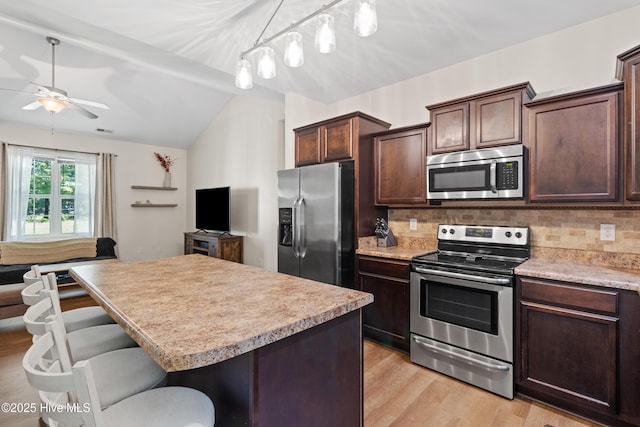5709 Burgaw Hwy, Maple Hill, NC 28454 - kitchen featuring stainless steel appliances, ceiling fan, lofted ceiling, light countertops, and backsplash