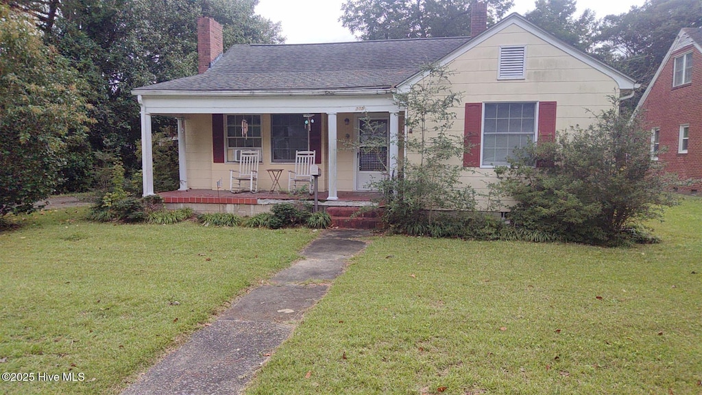 305 W Academy St, Williamston, NC 27892 - bungalow-style house featuring a chimney, a porch, and a front yard