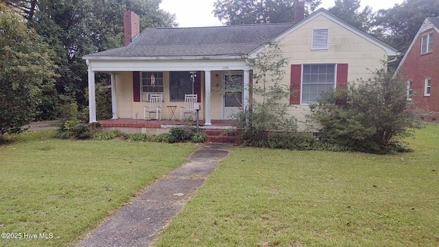 305 W Academy St, Williamston, NC 27892 - bungalow-style house featuring a chimney, a porch, and a front yard