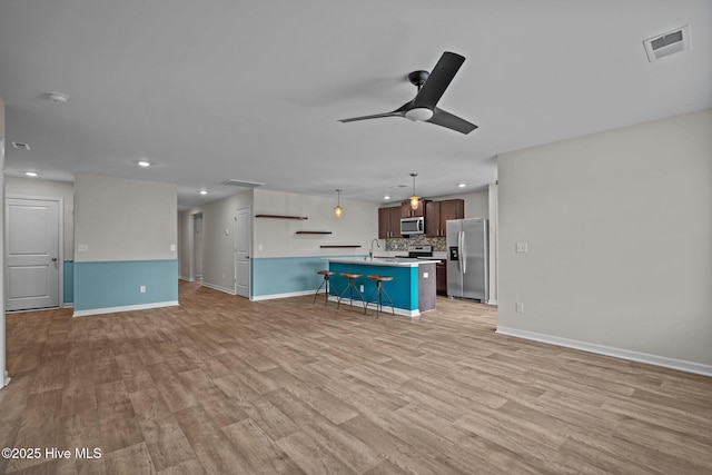 694 Chester Way NE, Leland, NC 28451 - unfurnished living room with recessed lighting, a ceiling fan, and light wood-type flooring
