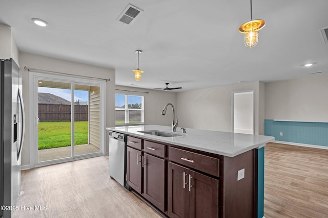 694 Chester Way NE, Leland, NC 28451 - kitchen featuring stainless steel appliances, light wood-type flooring, a ceiling fan, open floor plan, and decorative light fixtures