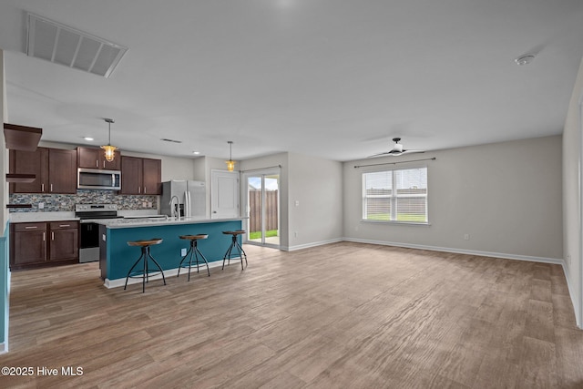 694 Chester Way NE, Leland, NC 28451 - kitchen with stainless steel appliances, tasteful backsplash, healthy amount of natural light, ceiling fan, and recessed lighting
