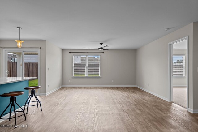694 Chester Way NE, Leland, NC 28451 - unfurnished living room with ceiling fan, light wood-style floors, and plenty of natural light
