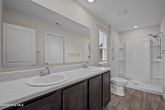 694 Chester Way NE, Leland, NC 28451 - bathroom featuring wood finished floors, a shower, and double vanity