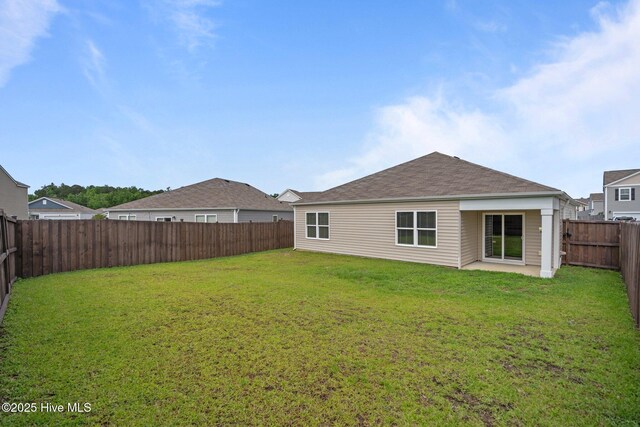 694 Chester Way NE, Leland, NC 28451 - back of house with a fenced backyard and roof with shingles
