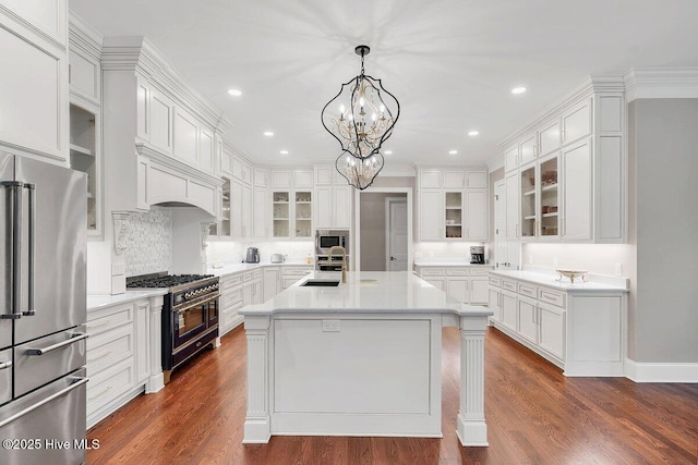 2270 Midland Rd, Pinehurst, NC 28374 - kitchen featuring high end appliances, light countertops, white cabinetry, a center island with sink, and recessed lighting