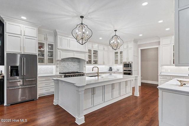 2270 Midland Rd, Pinehurst, NC 28374 - kitchen with appliances with stainless steel finishes, a chandelier, light countertops, backsplash, and white cabinetry