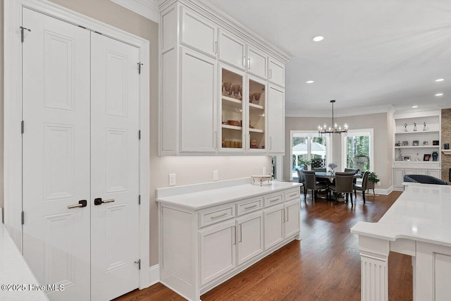 2270 Midland Rd, Pinehurst, NC 28374 - kitchen with white cabinets, dark wood-type flooring, ornamental molding, glass insert cabinets, and light countertops