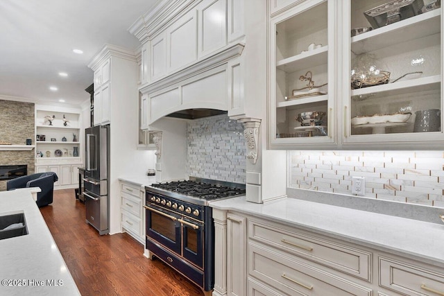 2270 Midland Rd, Pinehurst, NC 28374 - kitchen featuring range with two ovens, freestanding refrigerator, a stone fireplace, light countertops, and dark wood-style flooring