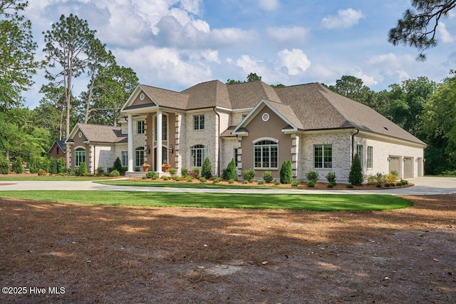 2270 Midland Rd, Pinehurst, NC 28374 - greek revival house featuring driveway, an attached garage, a front yard, and brick siding