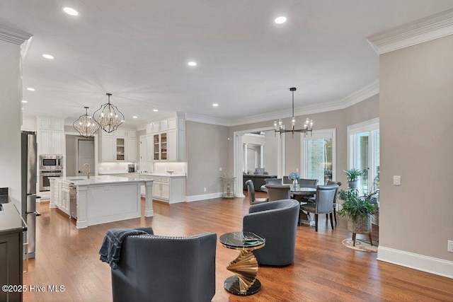 2270 Midland Rd, Pinehurst, NC 28374 - living room featuring a chandelier, wood finished floors, ornamental molding, and recessed lighting