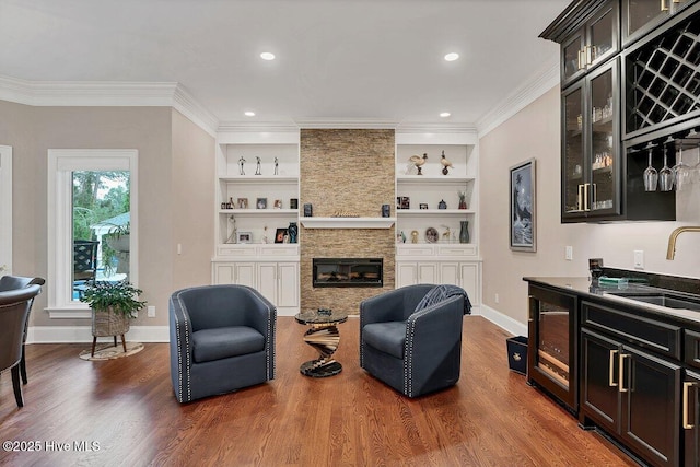 2270 Midland Rd, Pinehurst, NC 28374 - living room featuring dark wood-type flooring, crown molding, beverage cooler, a fireplace, and bar area