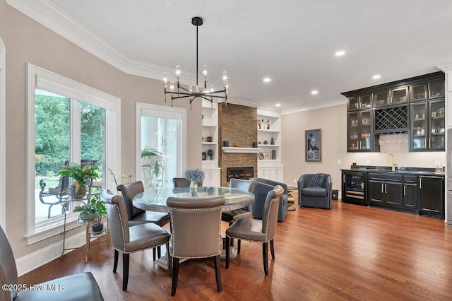 2270 Midland Rd, Pinehurst, NC 28374 - dining room with wine cooler, bar with sink, crown molding, wood finished floors, and a chandelier
