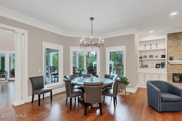 2270 Midland Rd, Pinehurst, NC 28374 - dining space with dark wood-style floors, a chandelier, ornate columns, crown molding, and built in features