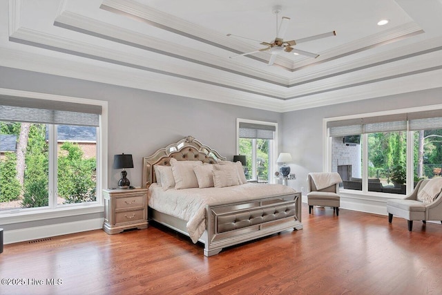 2270 Midland Rd, Pinehurst, NC 28374 - bedroom featuring a raised ceiling, crown molding, wood finished floors, and ceiling fan