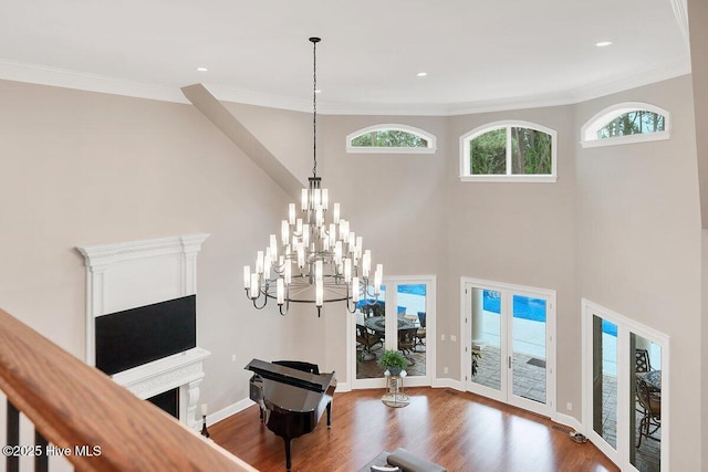 2270 Midland Rd, Pinehurst, NC 28374 - living area with wood finished floors, a chandelier, a towering ceiling, ornamental molding, and recessed lighting