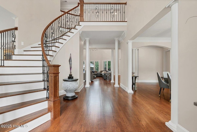 2270 Midland Rd, Pinehurst, NC 28374 - entrance foyer featuring crown molding, wood finished floors, arched walkways, stairway, and a towering ceiling