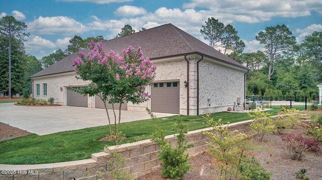 2270 Midland Rd, Pinehurst, NC 28374 - view of home's exterior with a garage, driveway, roof with shingles, and brick siding