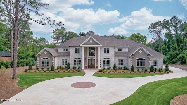 2270 Midland Rd, Pinehurst, NC 28374 - neoclassical home with a front yard, french doors, curved driveway, and a chimney