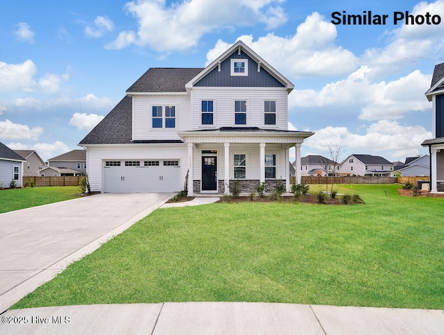 107 N Alena Ct, Hampstead, NC 28443 - craftsman house featuring concrete driveway, a porch, board and batten siding, an attached garage, and stone siding